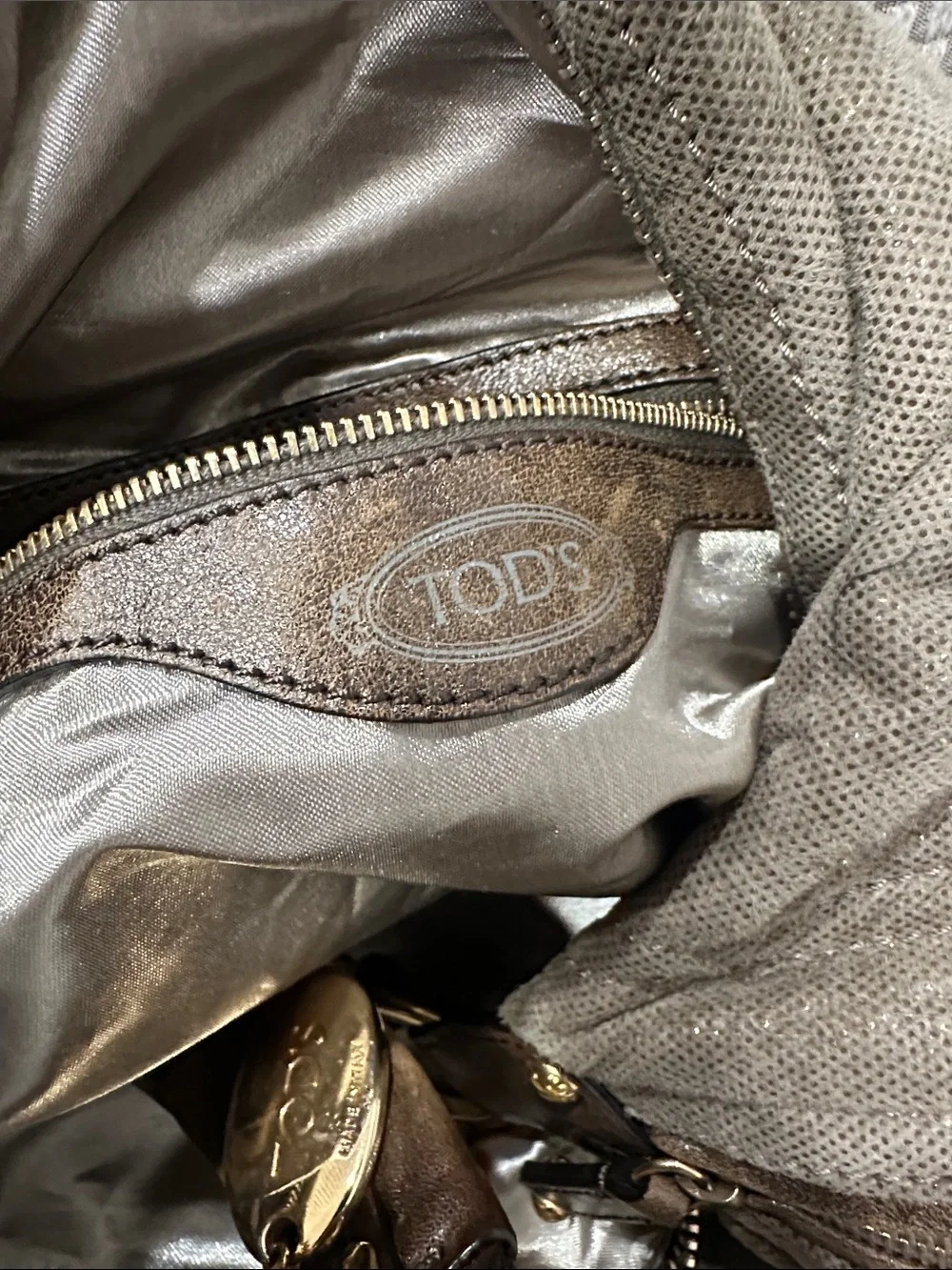 Tod’s Soft Metallic Taupe Hobo Bag with Gold Hardware. Lots of pockets,